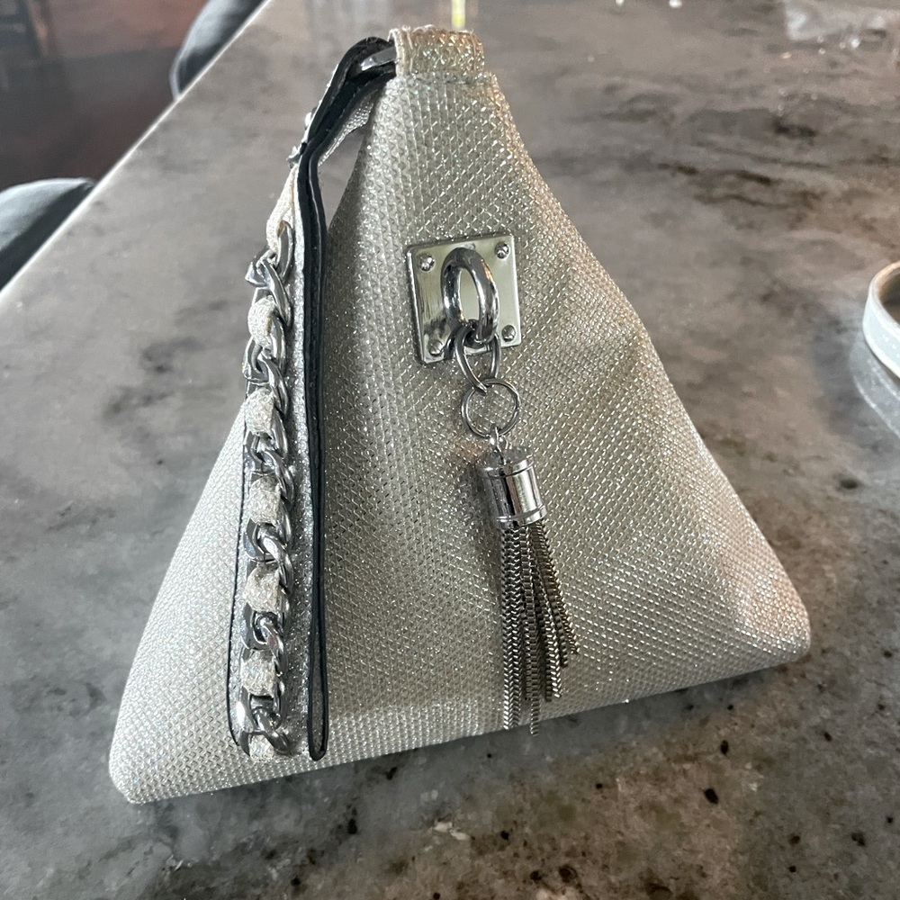 Silver purse with hand strap. Super cute! Triangle shape or can be folded!prom
